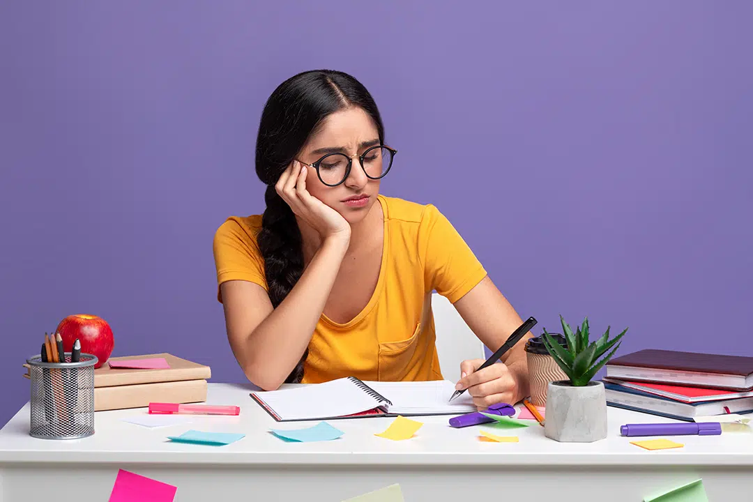 Young girl stressfully studying